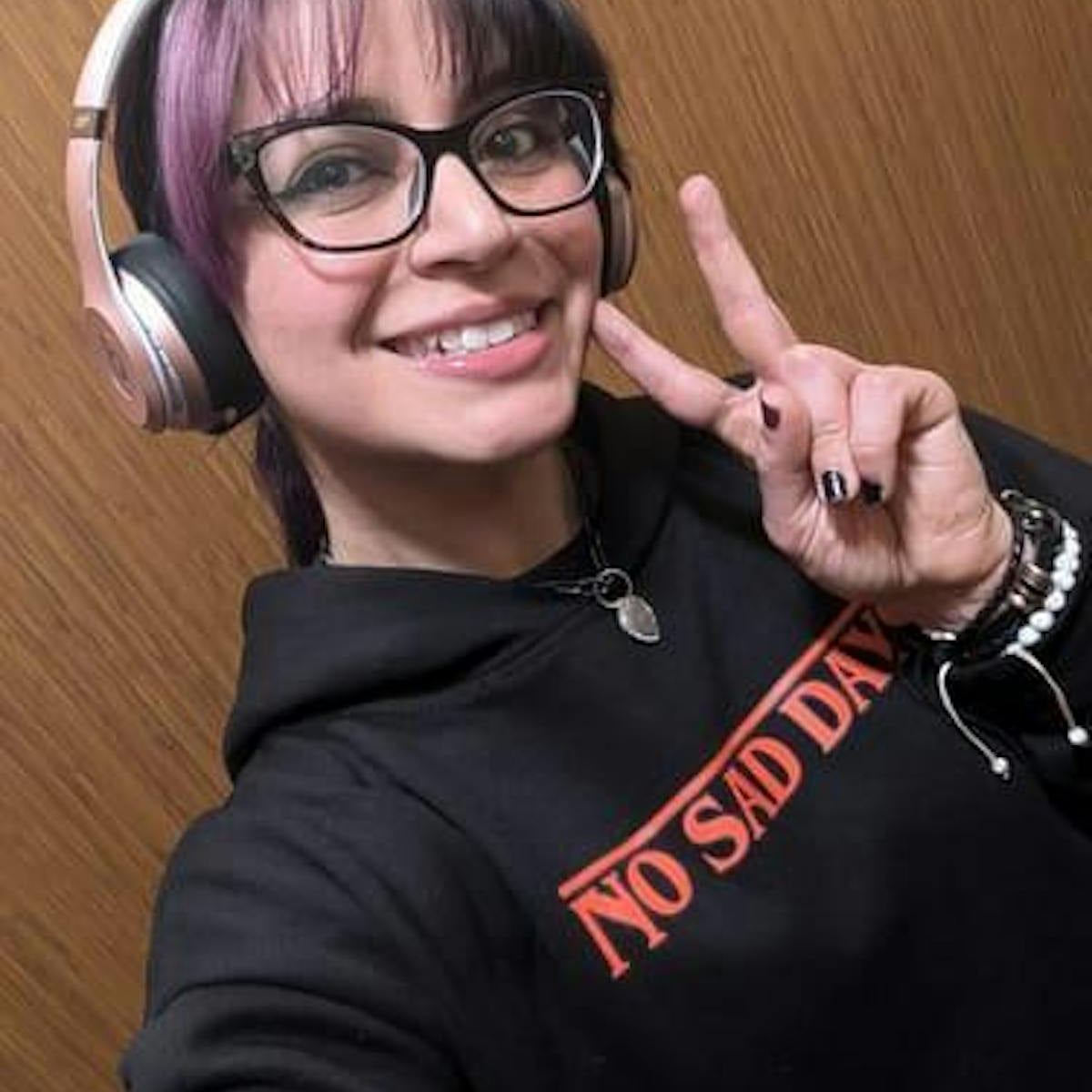 Customer selfie wearing Upside Down hoodie with headphones, front print